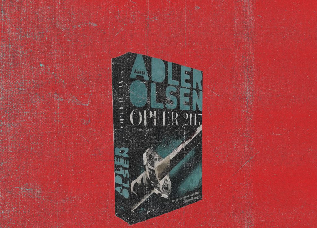 Ein Buch mit dem Titel „Opfer 2117“ von Adler Olsen ist schräg auf einem roten, strukturierten Hintergrund platziert. Das Buchcover ist dunkel mit türkisfarbenen und weißen Schriftzügen sowie einer grafischen Darstellung.